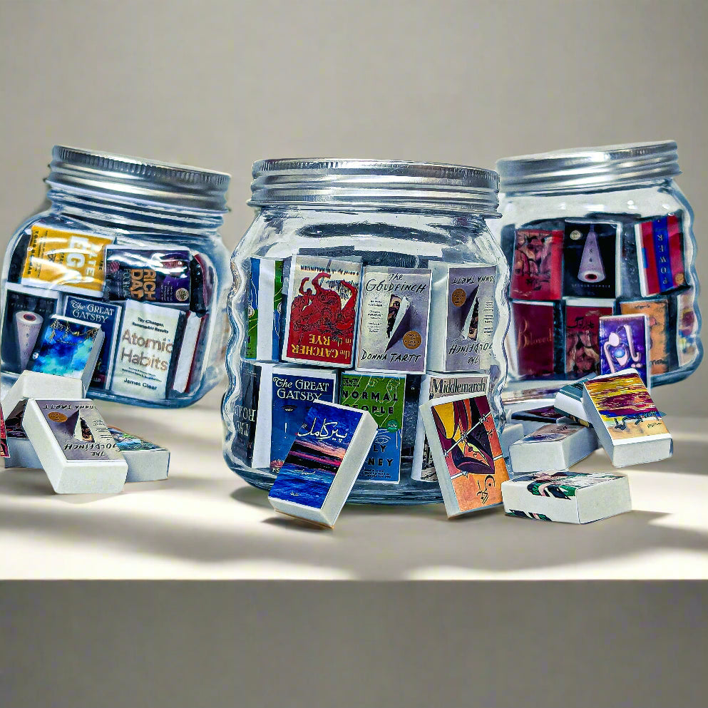 Three jars filled with colorful matchbooks on a white background